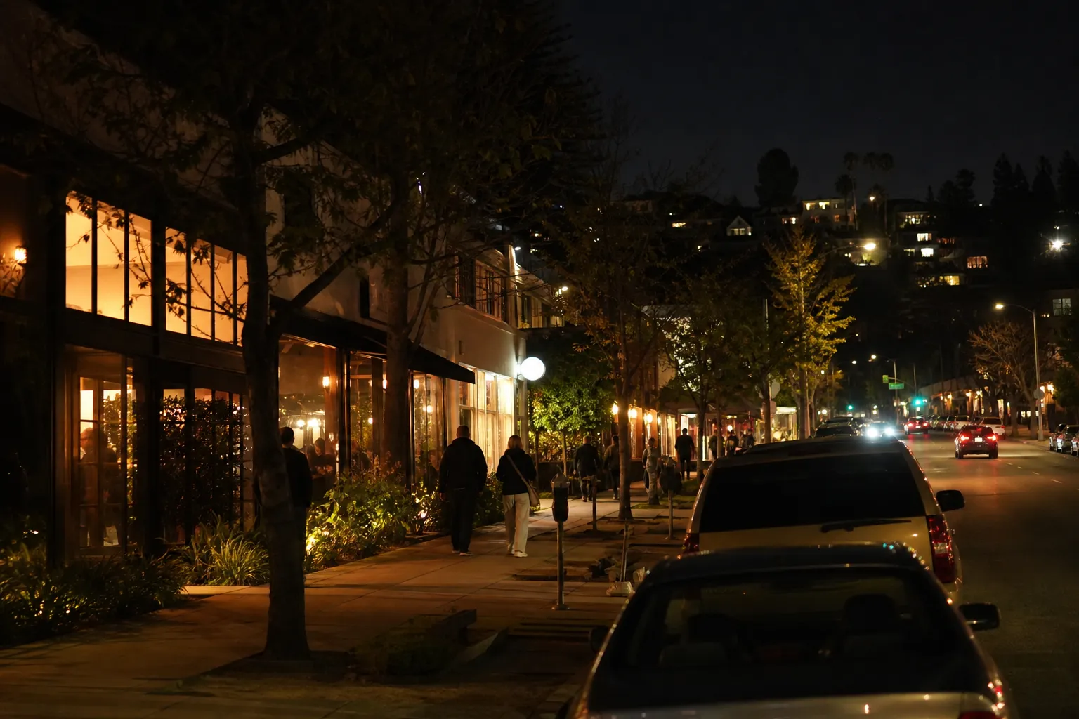 Night street scene with warm cafe windows along a Los Feliz commercial block