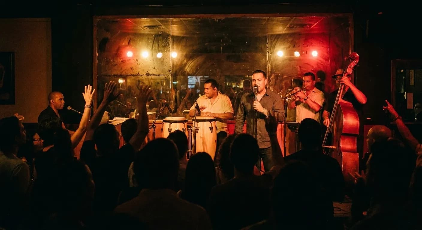 A five-piece Cuban band on a low stage in a small Little Havana bar late at night, congas and trumpet lit in warm red and amber with silhouetted heads in front