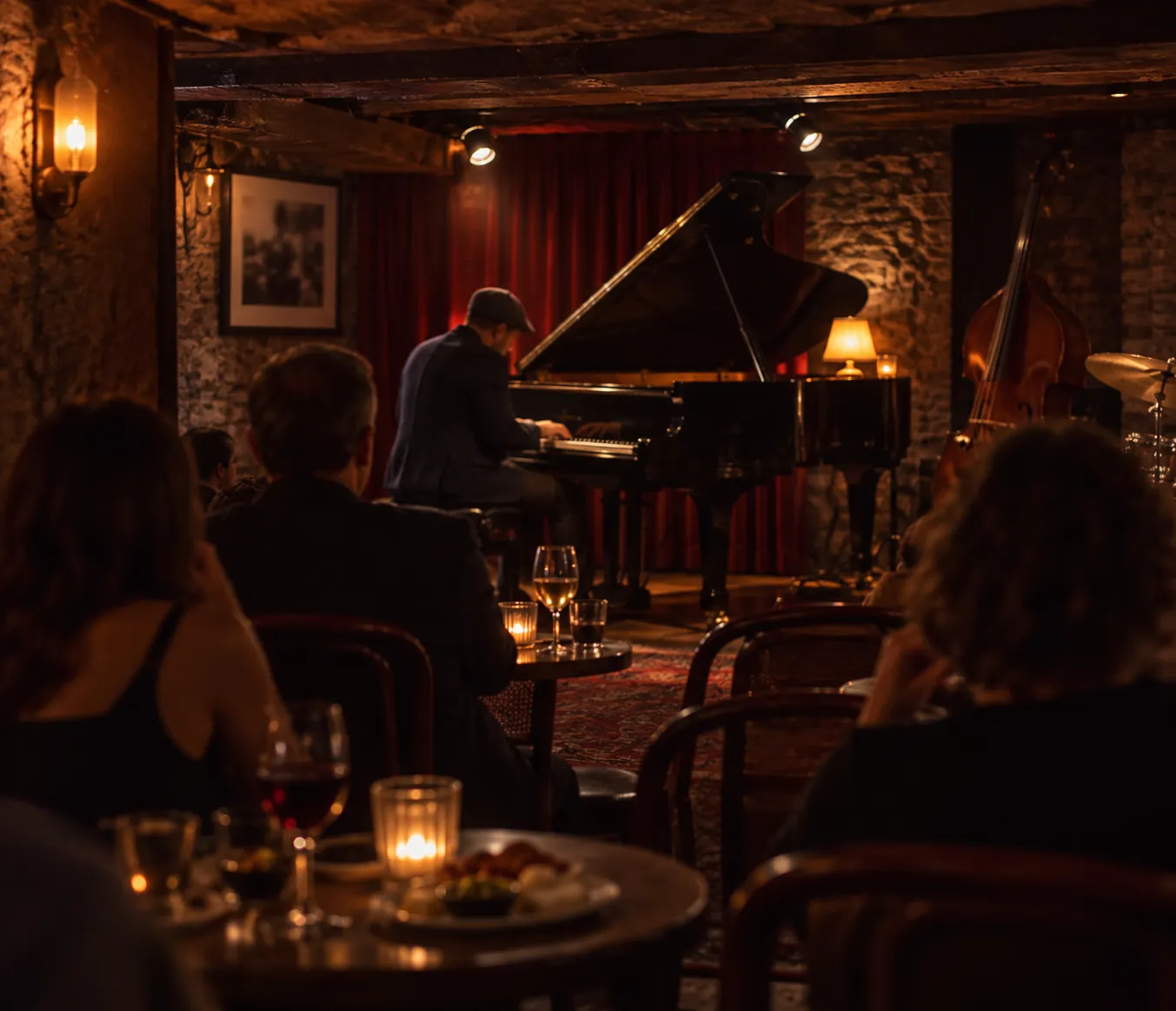 A small underground jazz room with a piano, low ceiling and a handful of chairs facing the stage