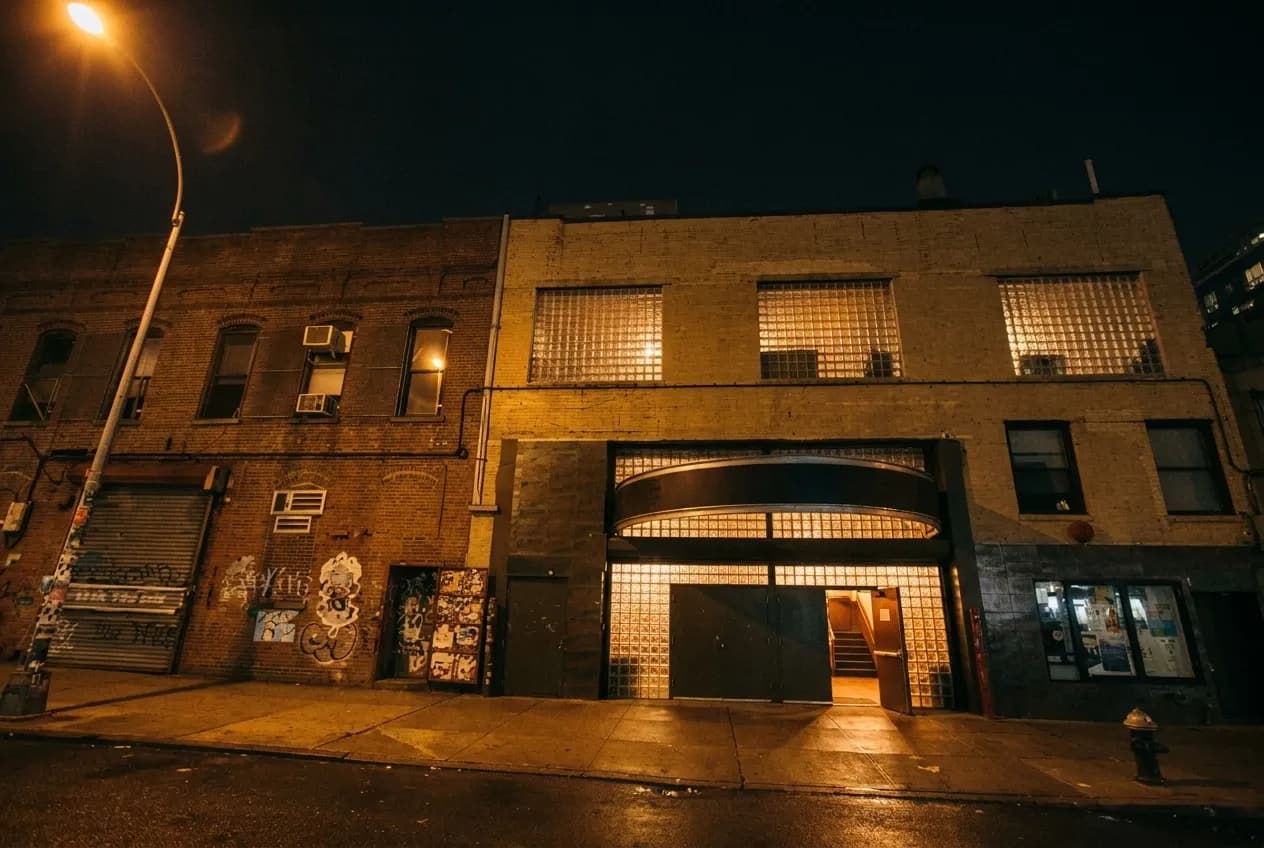 Night exterior of a small music venue on a quiet Brooklyn street