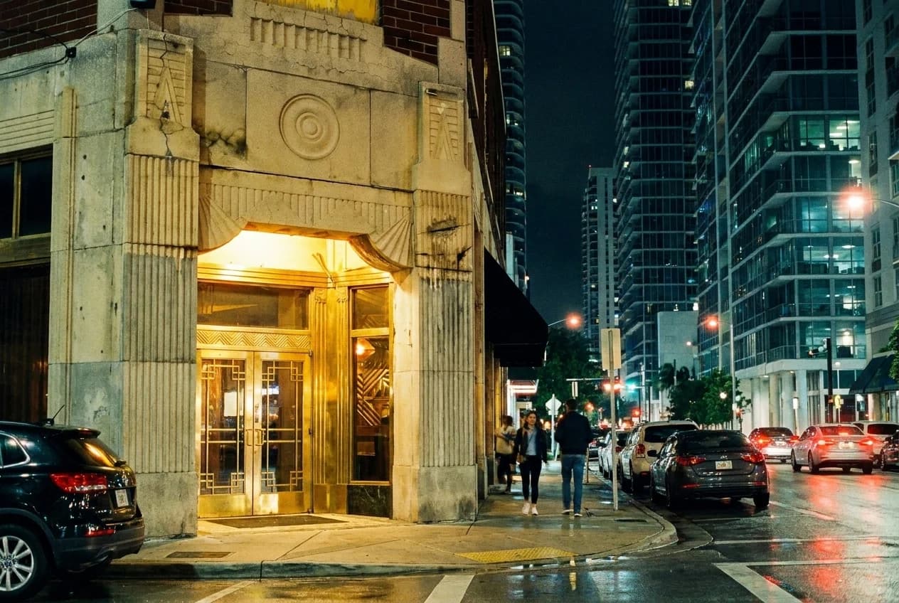 Art Deco supper club entrance in Brickell with brass details and lit interior visible through glass