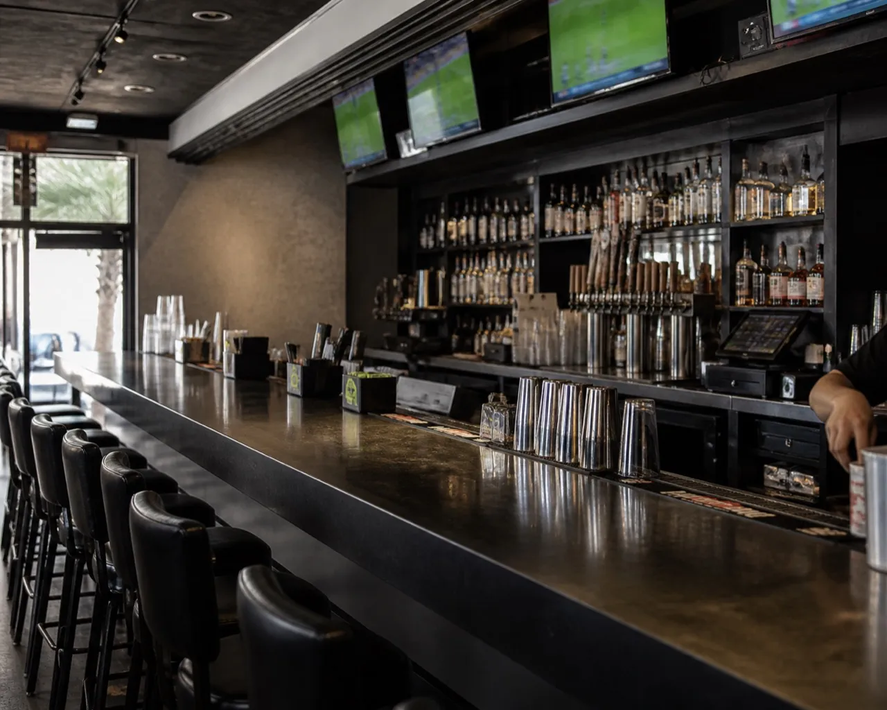 Sports bar counter with screens above the back bar