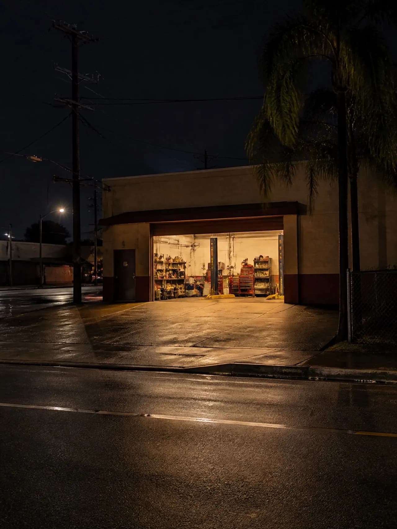 Converted garage record shop lit at night behind a bar