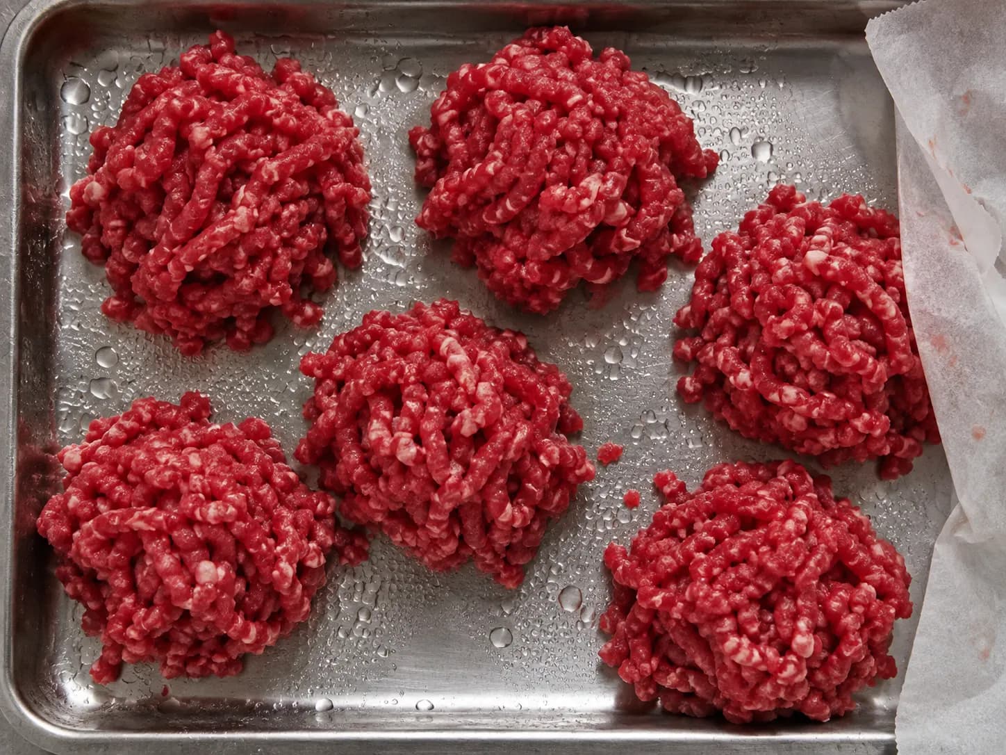 Coarse ground beef portioned on a steel tray