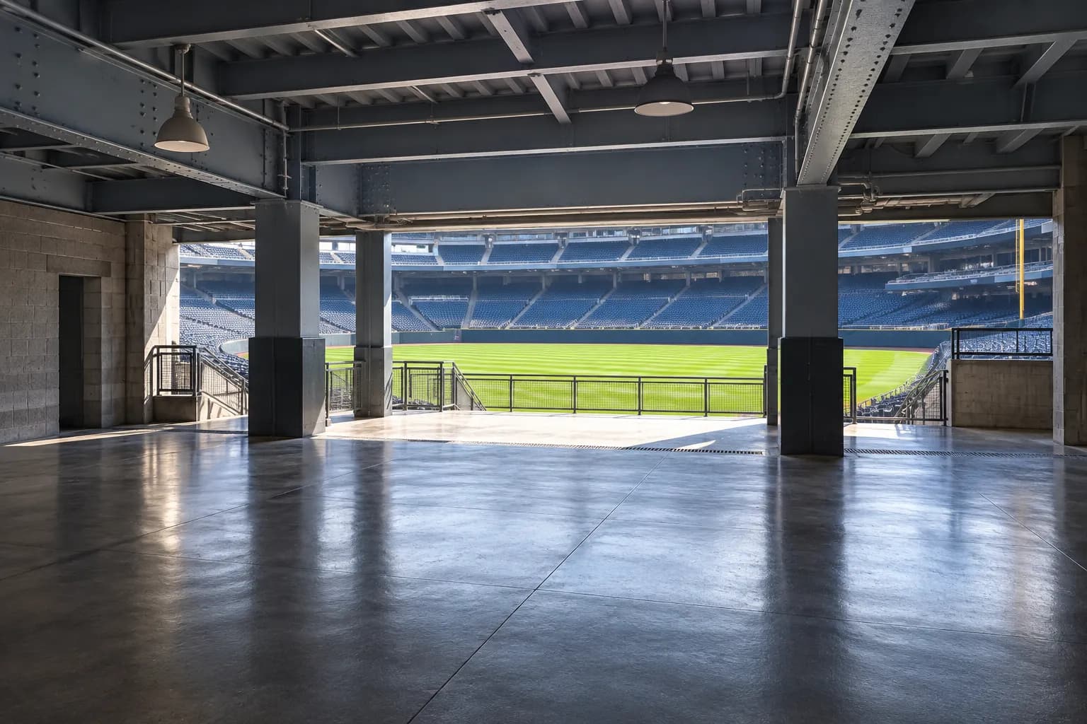 An empty baseball stadium concourse opening onto the field