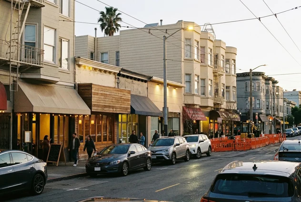 A neighbourhood restaurant row in San Francisco in evening light with mixed signage