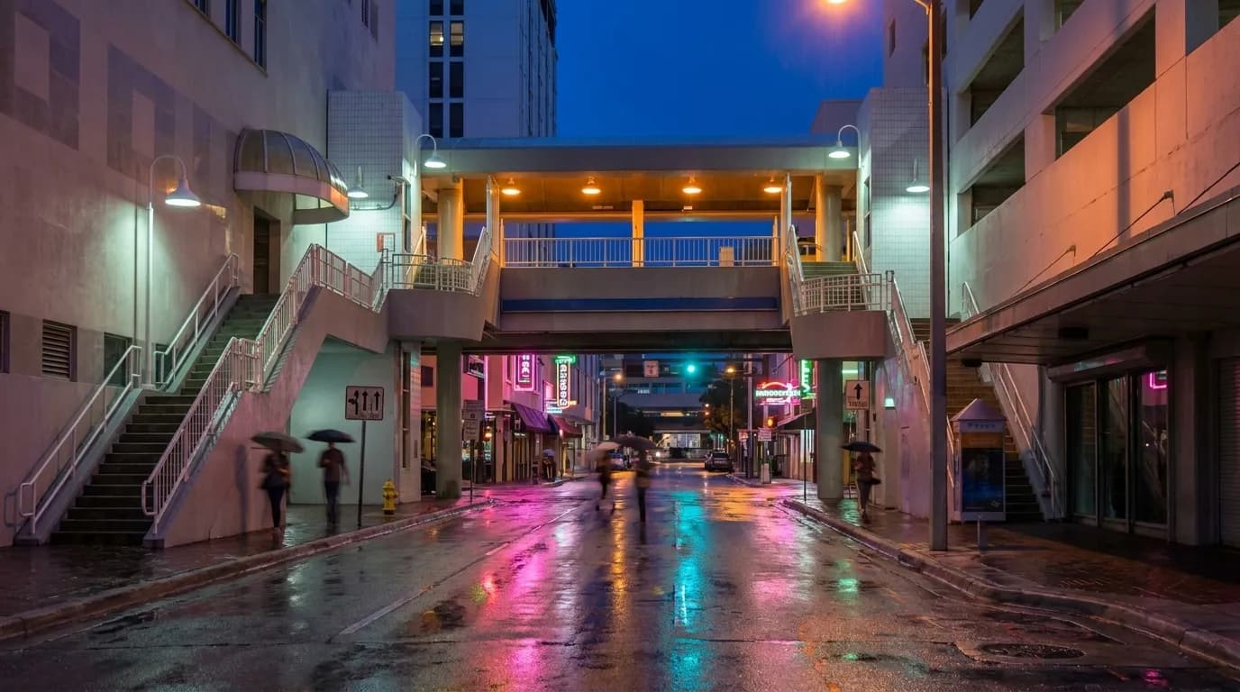 Washington Avenue in South Beach at night with neon reflections on wet pavement