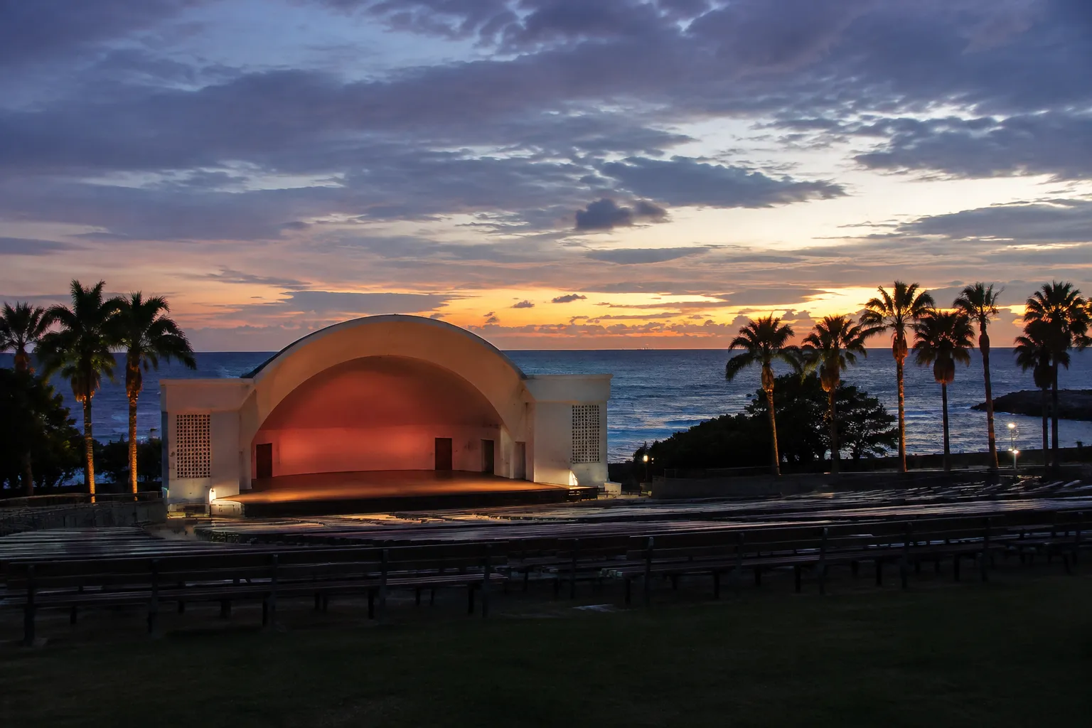 North Beach Bandshell outdoor amphitheater stage with ocean backdrop and palm trees at dusk in Miami Beach