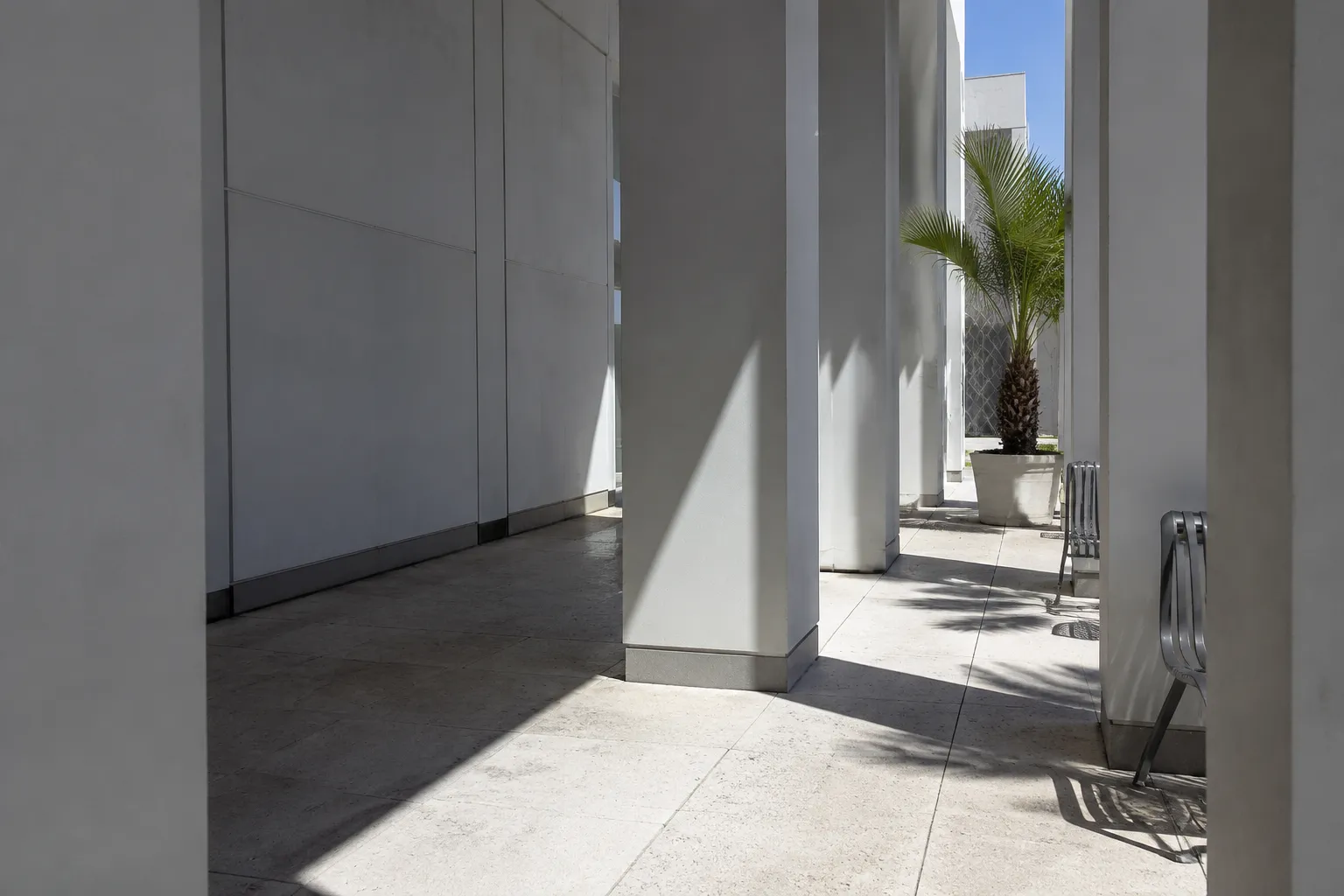 Shaded arcade colonnade in Miami Design District with geometric shadows