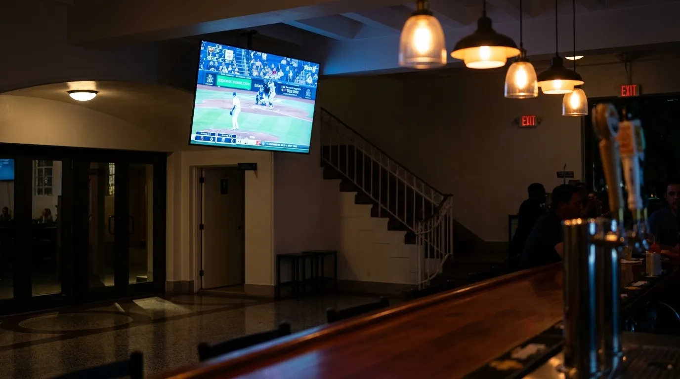 TV screen showing baseball game inside a Miami sports bar with dim ambient lighting