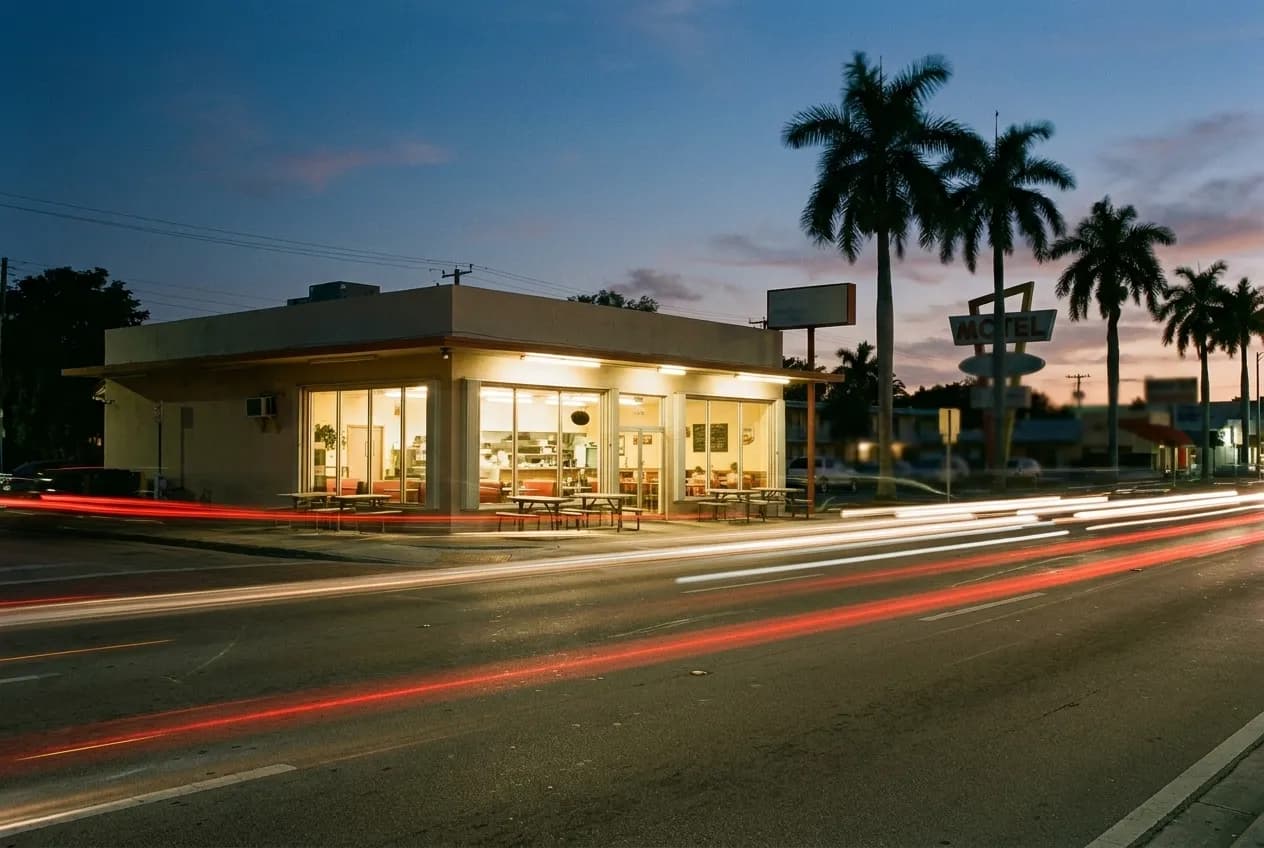 A corner restaurant with warm window light on Biscayne Boulevard in Miami's Upper Eastside after sunset