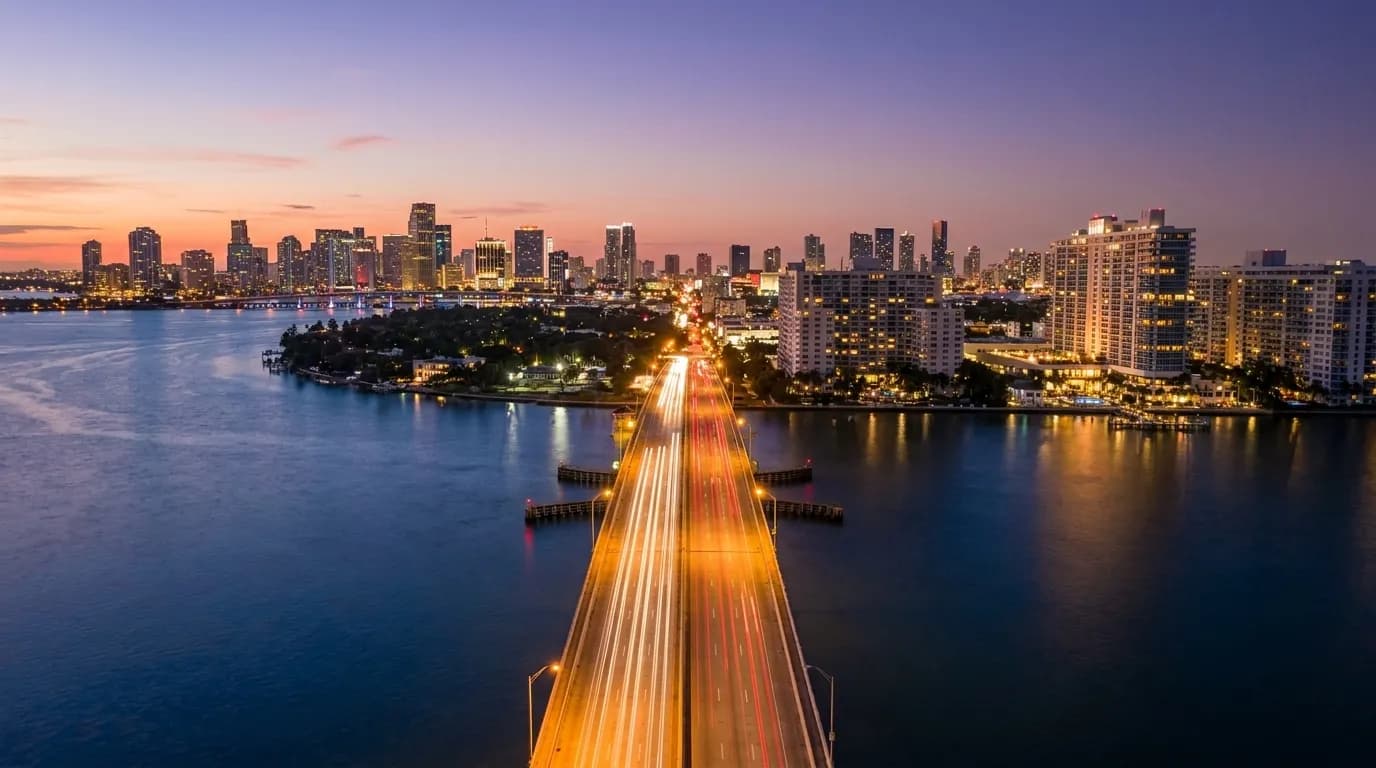 MacArthur Causeway bridge at dusk with Miami skyline in the distance