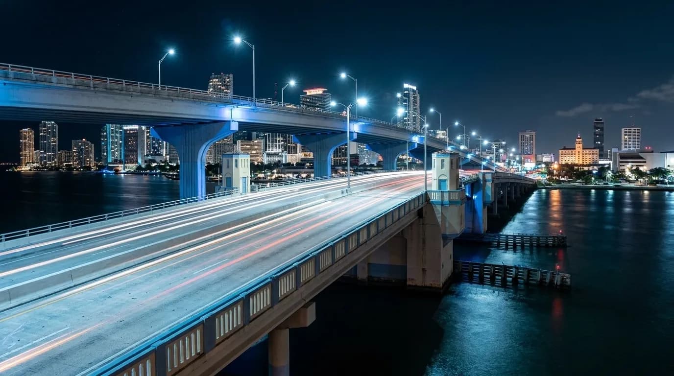 MacArthur Causeway bridge at night with Miami skyline in background