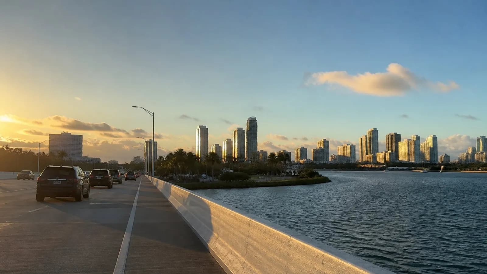 Traffic crossing the MacArthur Causeway toward Miami Beach near sunset.