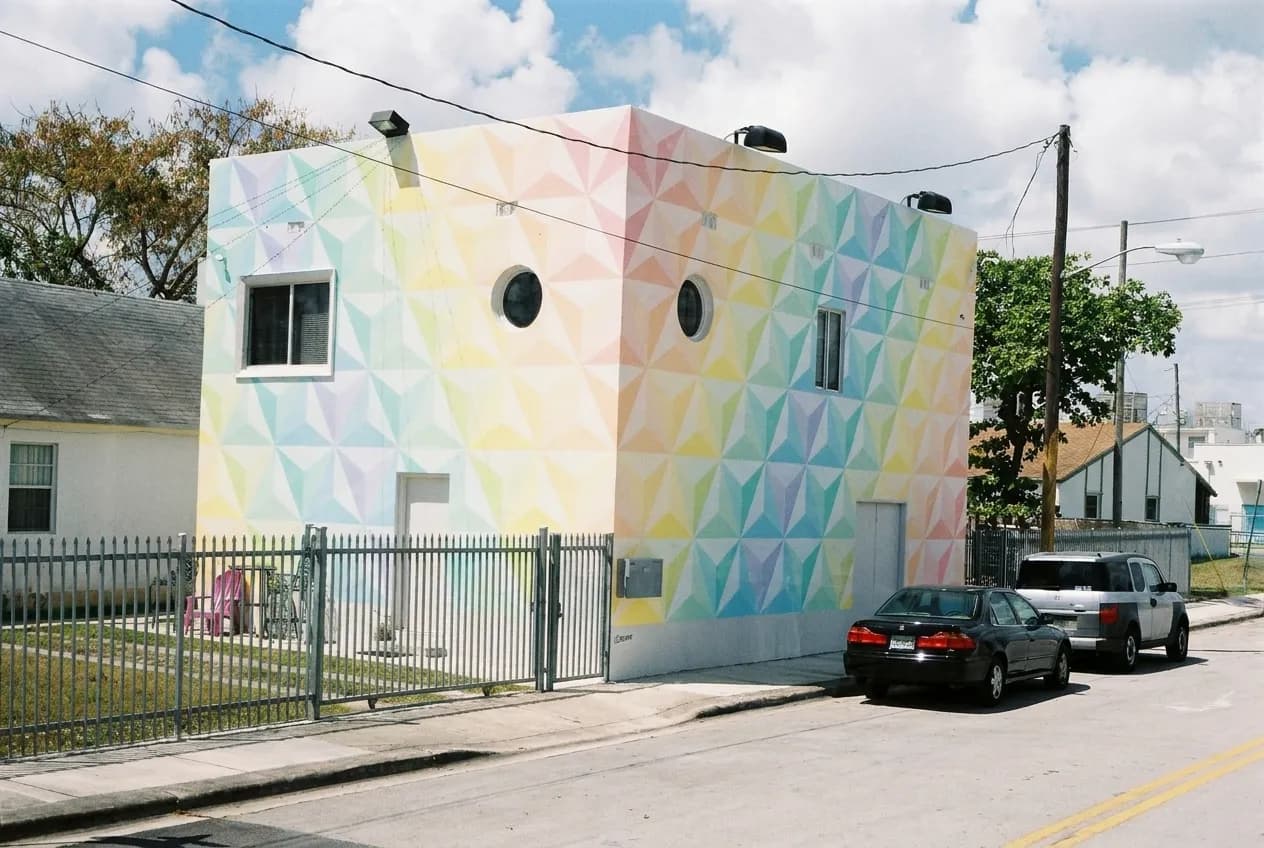 Converted warehouse buildings under a wide sky in an inland Miami district