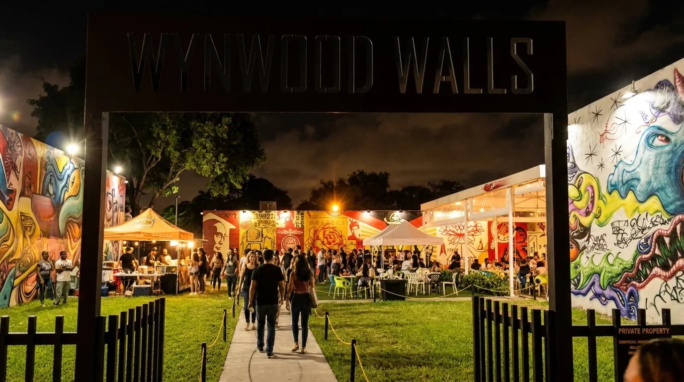 Illuminated murals and street art in Wynwood at night with festival crowds