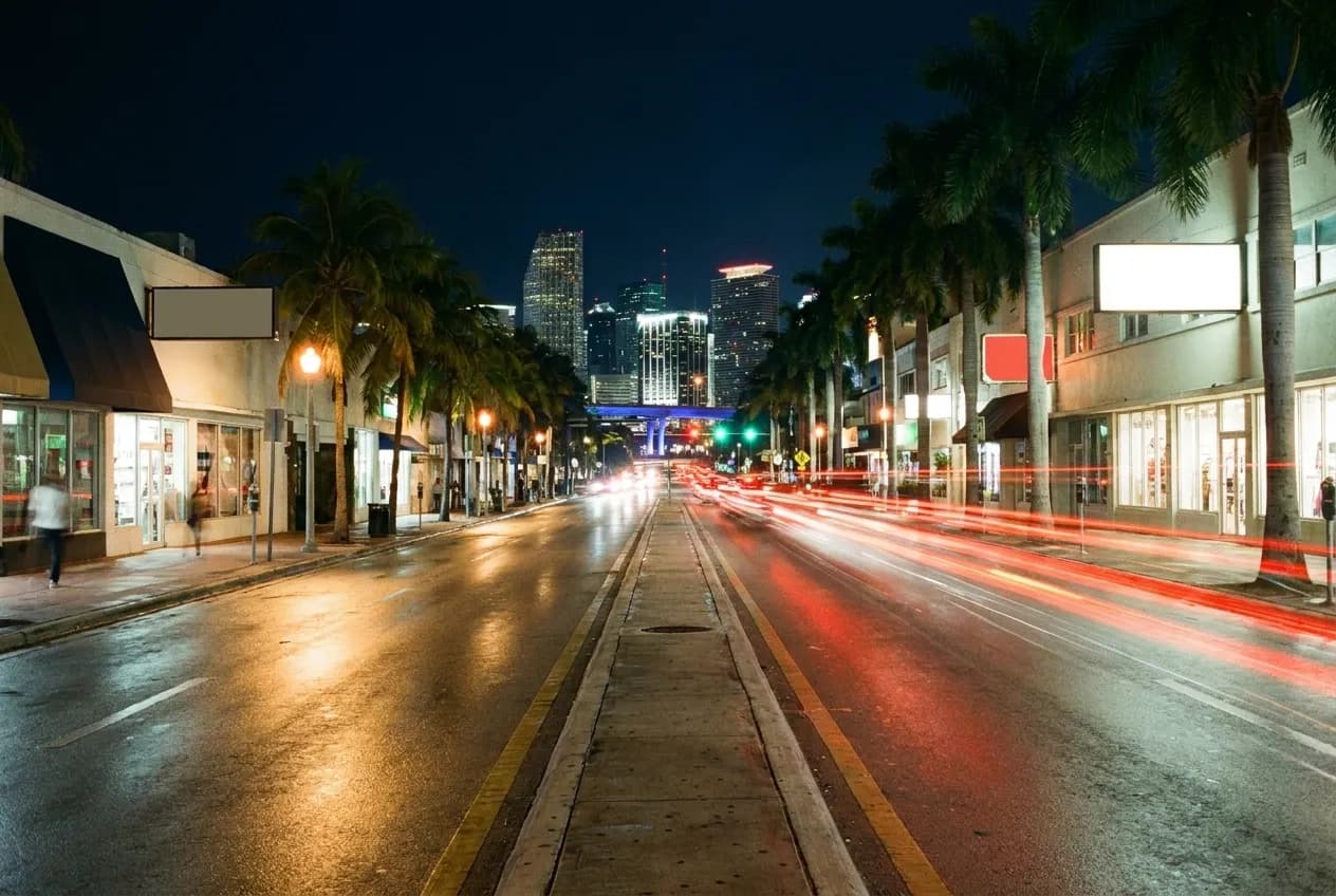 A wide boulevard at night, signal lights running away into the distance