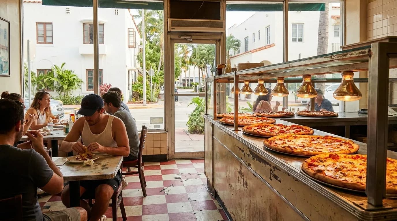 Pizza counter with fresh pies under heat lamps