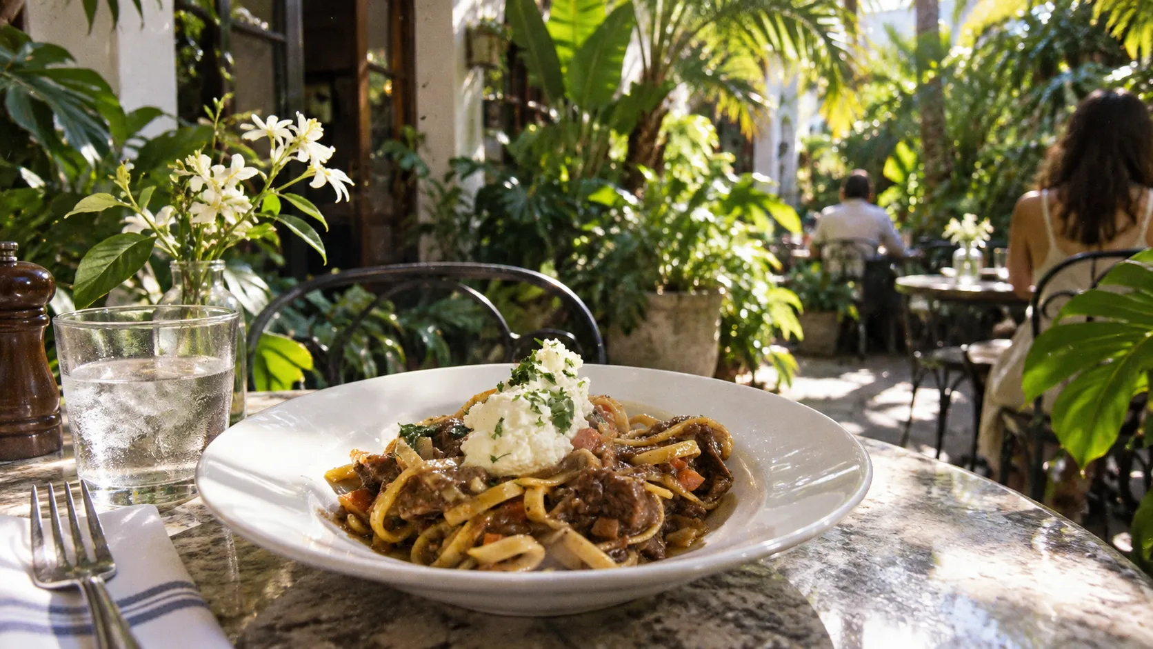 Just outside Michael’s Genuine, a semi-private courtyard places small tables among tropical plants along sunlit 40th Street.