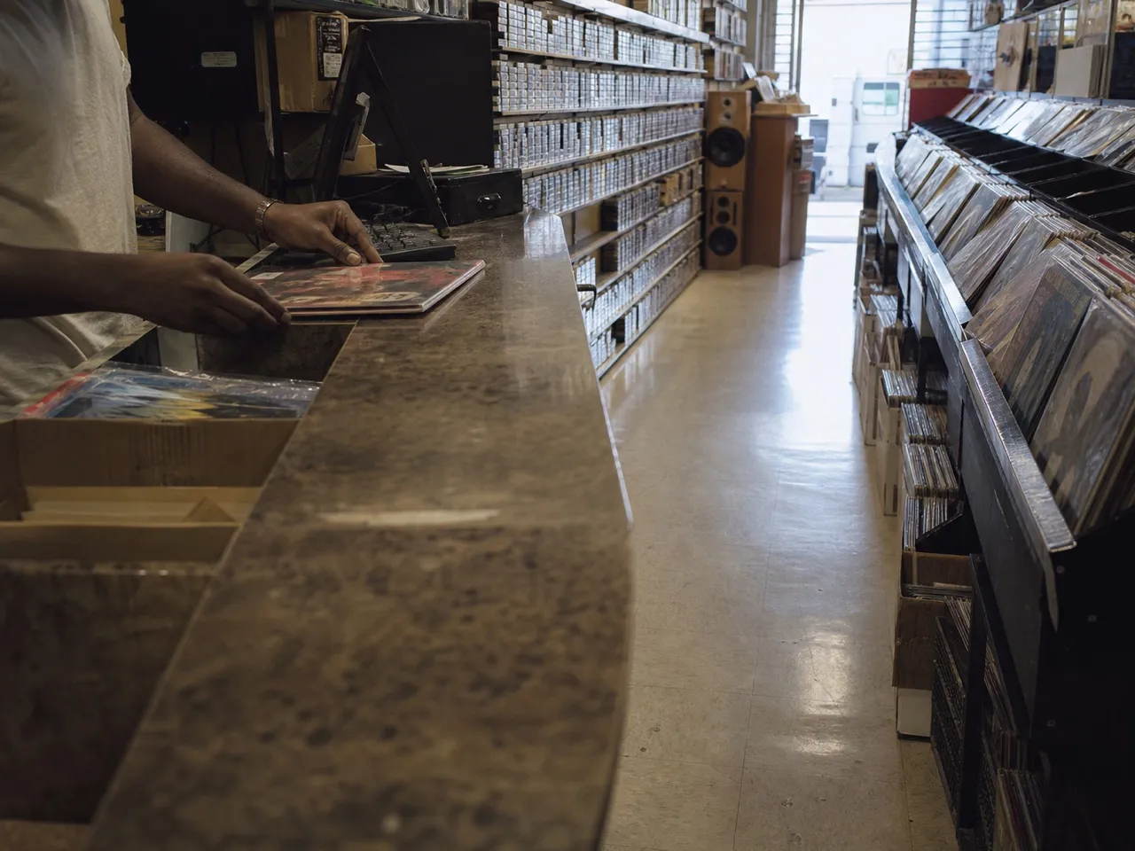 Record shop aisle with vinyl and cassettes