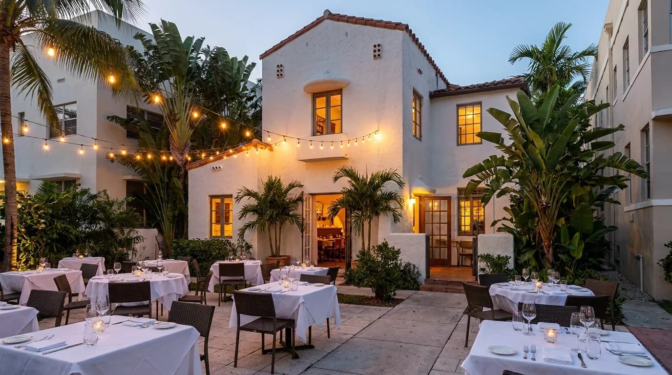 Modern Miami restaurant exterior with outdoor seating at dusk
