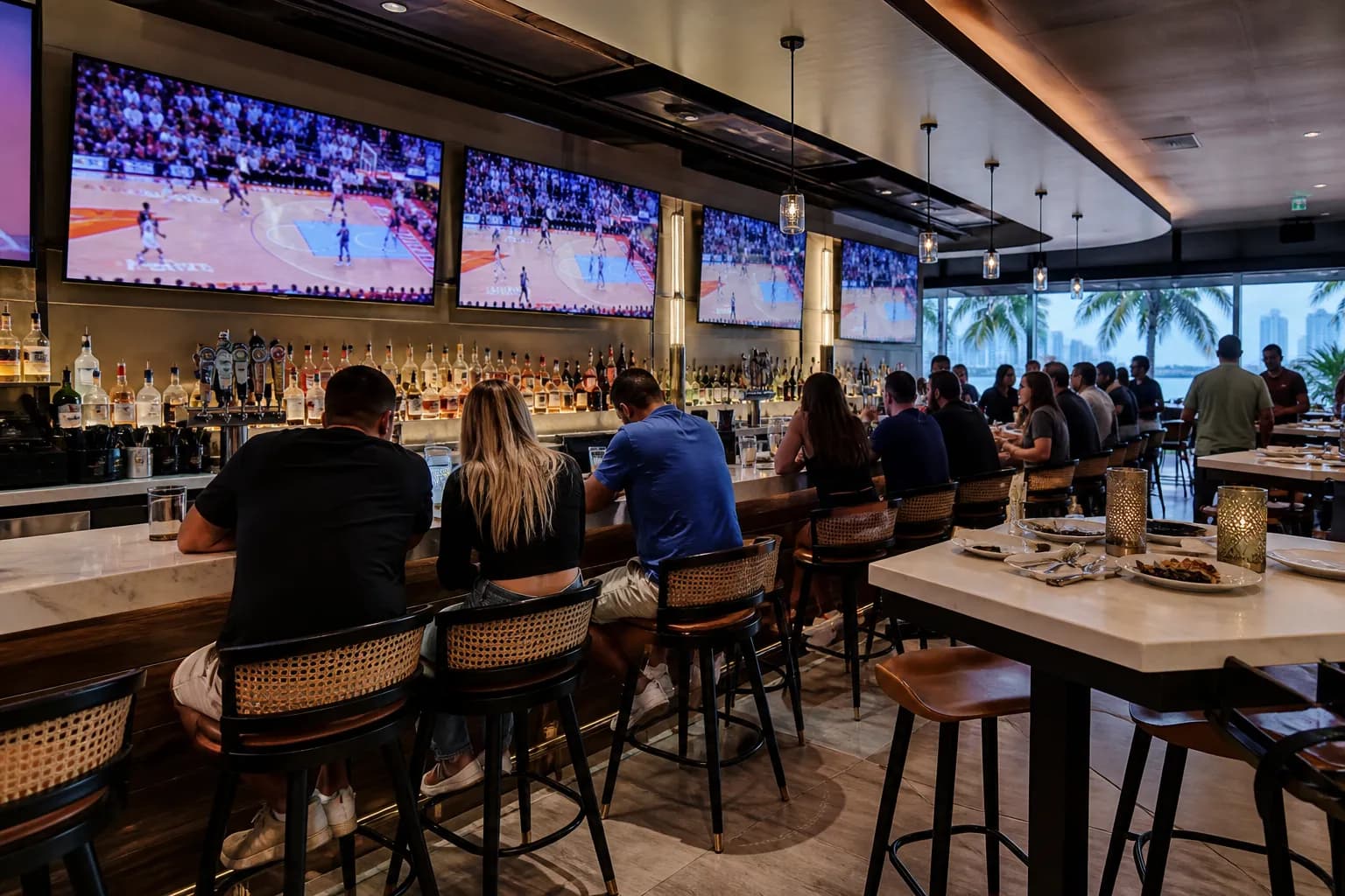 Interior bar counter with multiple TVs and game-night lighting