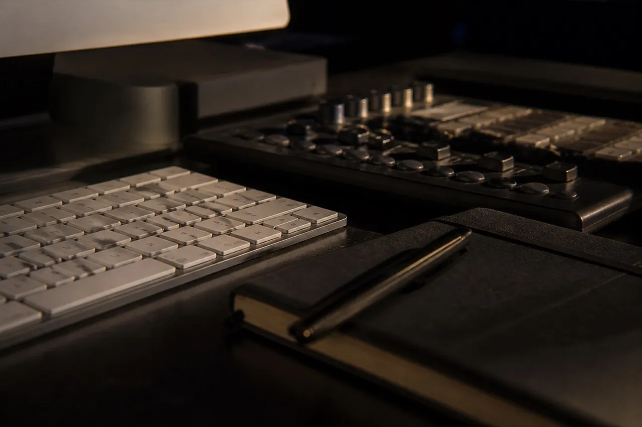 Editing desk with a keyboard and colour-graded frames on screen