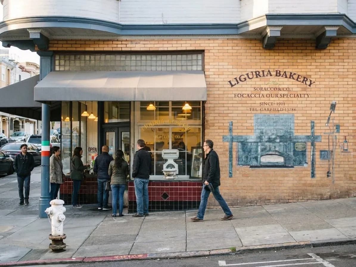 An old-world bakery storefront on a North Beach corner in morning light