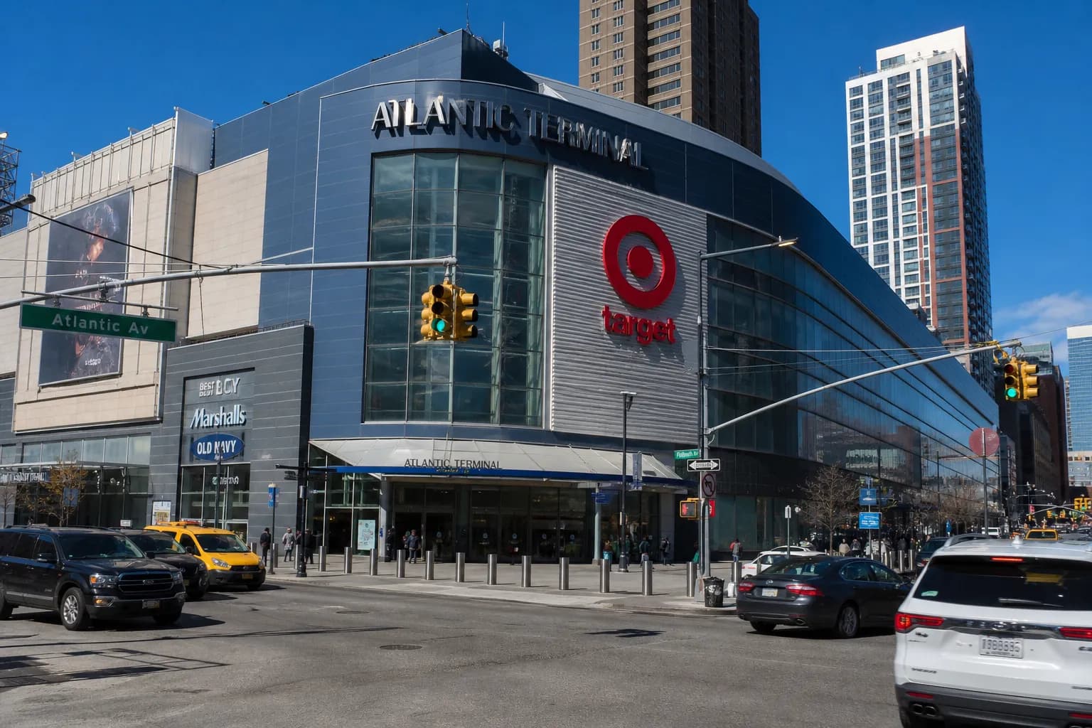 A modern glass storefront of a Target store in Downtown Brooklyn with a red bullseye logo integrated into the urban streetscape.