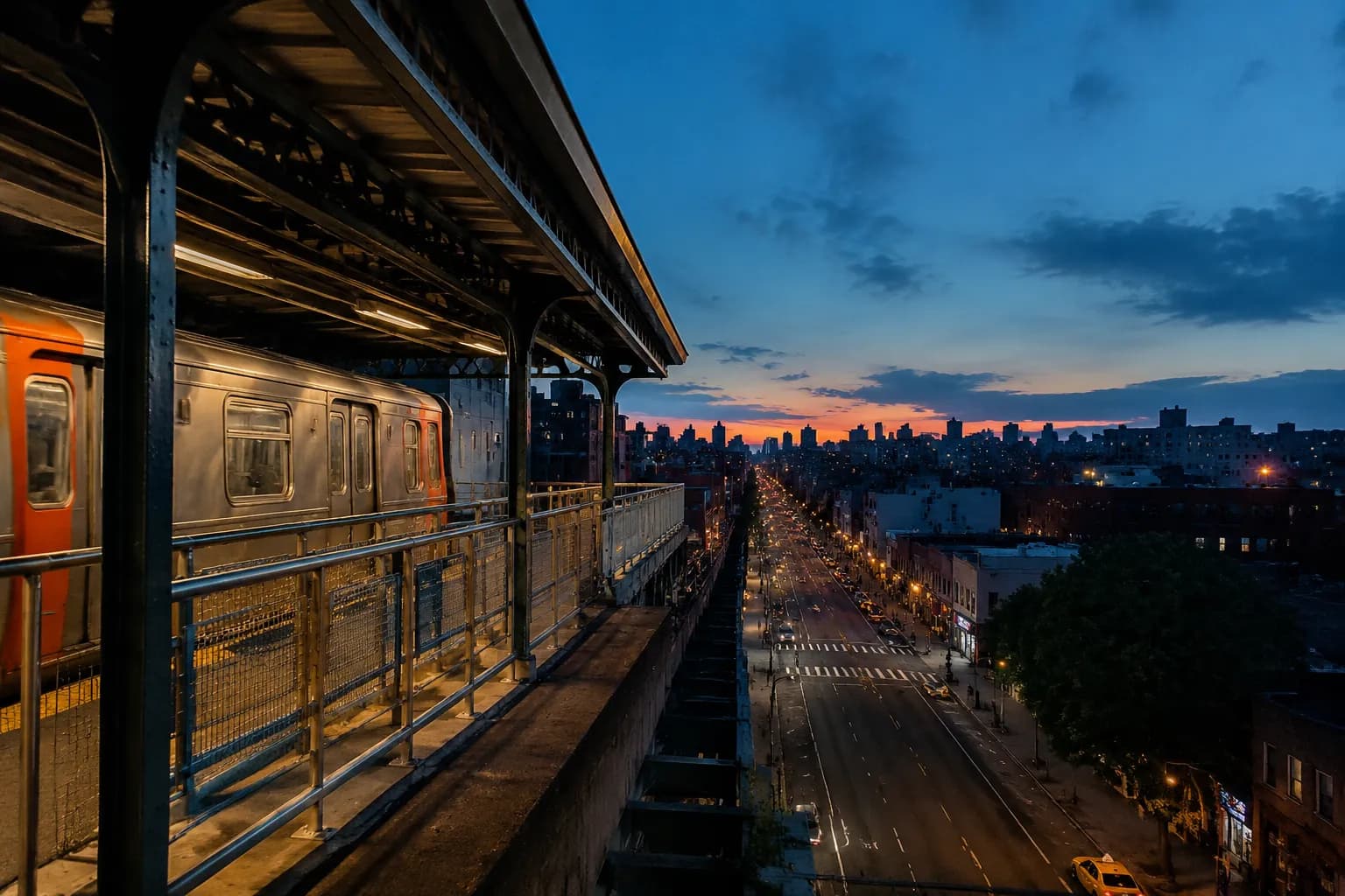 Elevated 7 train platform at Woodside station in Queens during early evening, with Roosevelt Avenue visible below
