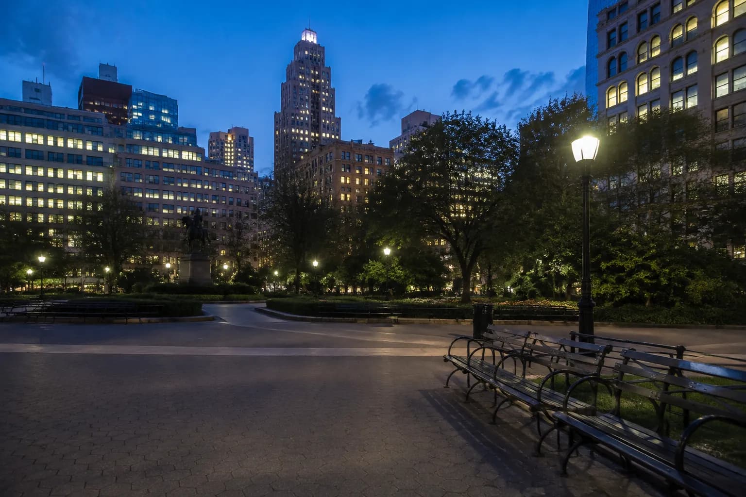 Union Square park benches at dusk with pathways and surrounding buildings