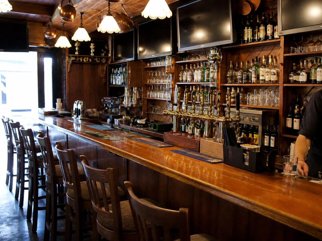 Pub counter with taps and stools before opening