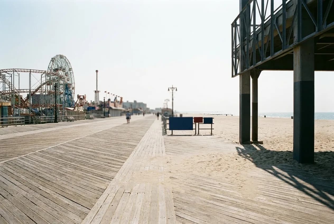 The boardwalk running east, beach on one side and rides rising on the other