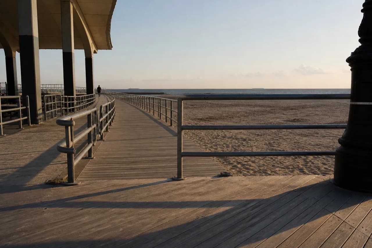 Coney Island boardwalk running toward the open ocean horizon
