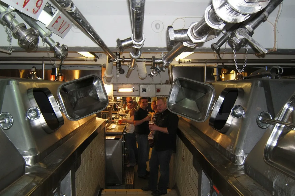 Brewery fermentation tanks behind a taproom bar