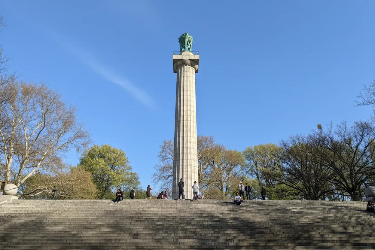 A tall Doric column monument atop a park staircase