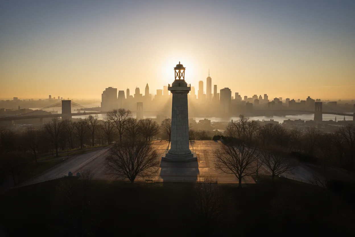 Sunrise over a Brooklyn park hilltop monument
