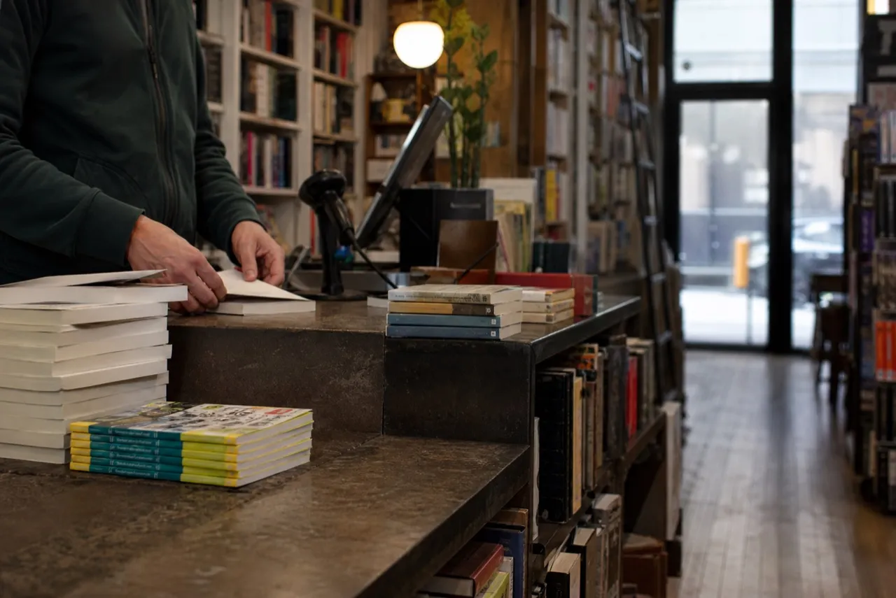Manhattan bookshop interior with shelving and a service counter