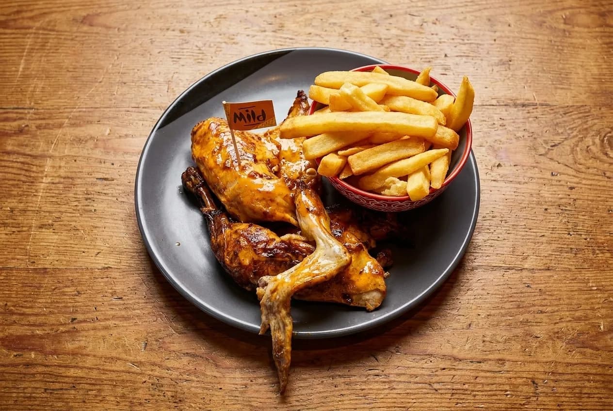 A single plate set down on a bare wood table, photographed from above