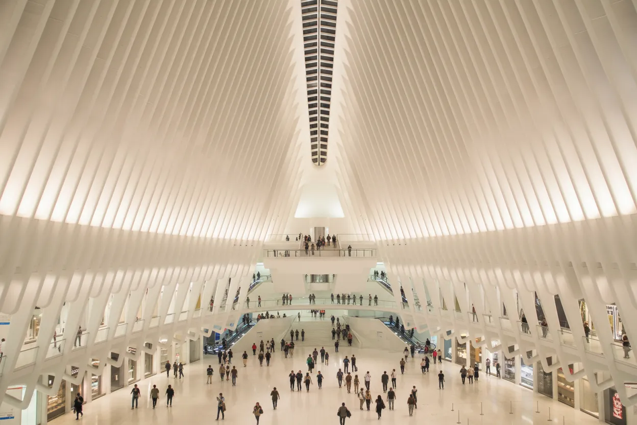The soaring white interior of a rib-vaulted transit hall
