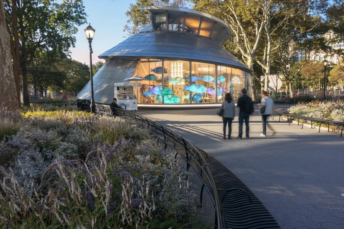 A modern nautilus-style carousel in a glass pavilion