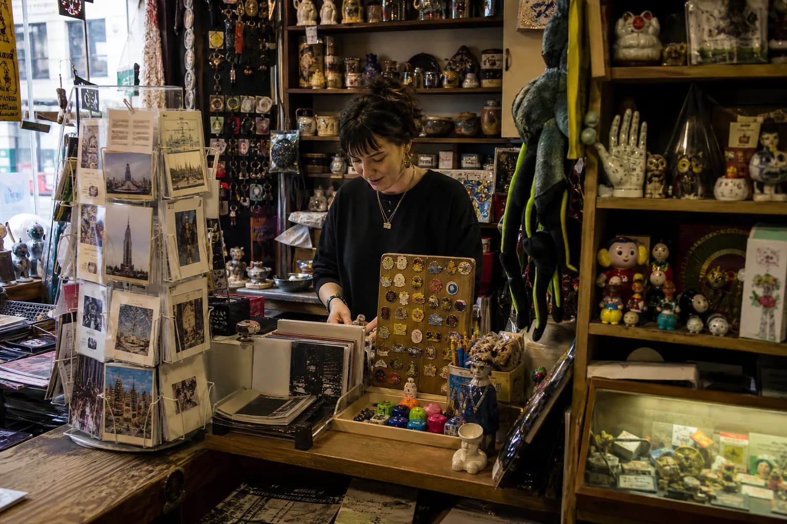 Packed counter inside a tiny New York shop with odd trinkets and postcards