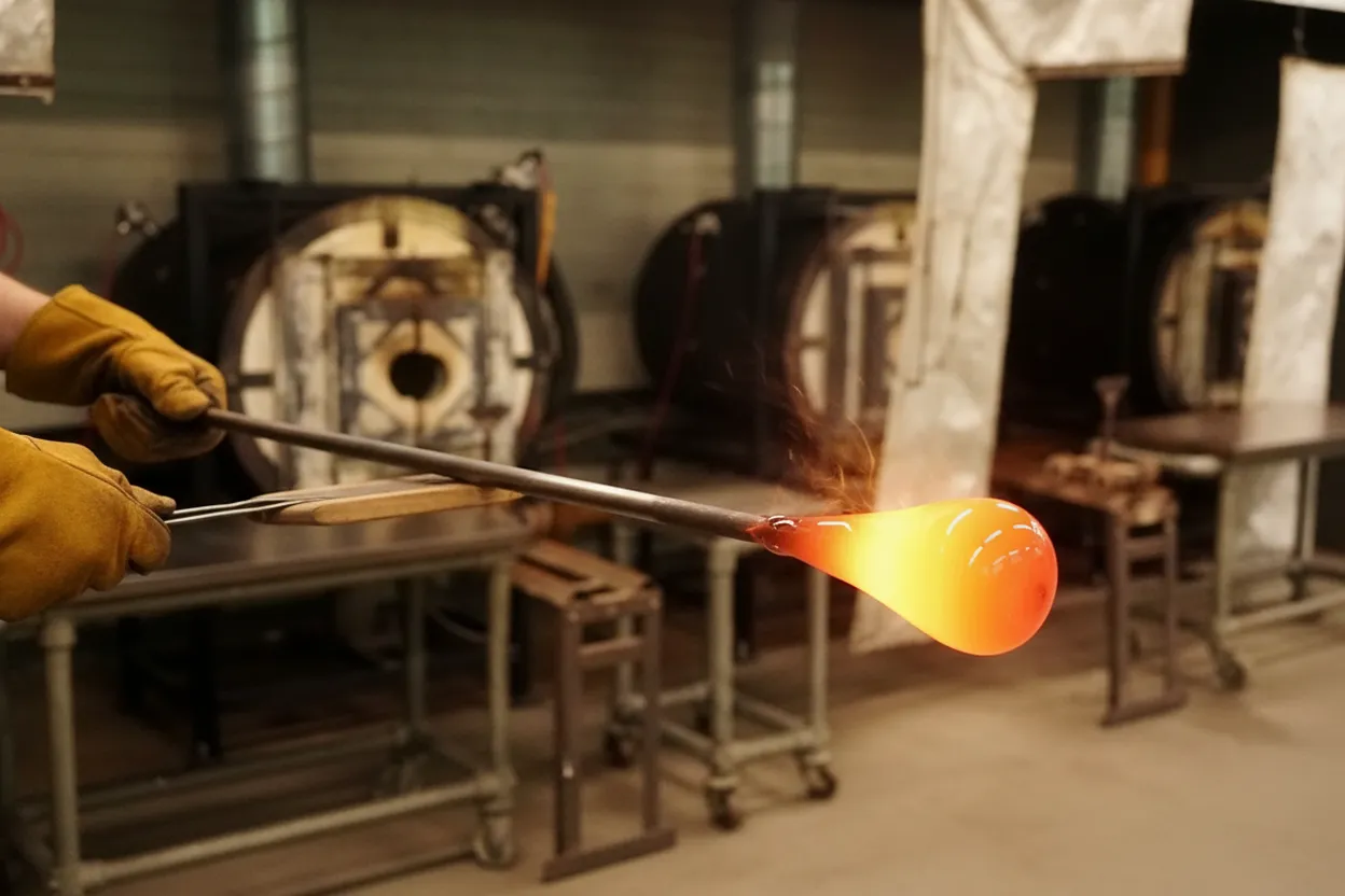 Molten glass being shaped in a hot shop