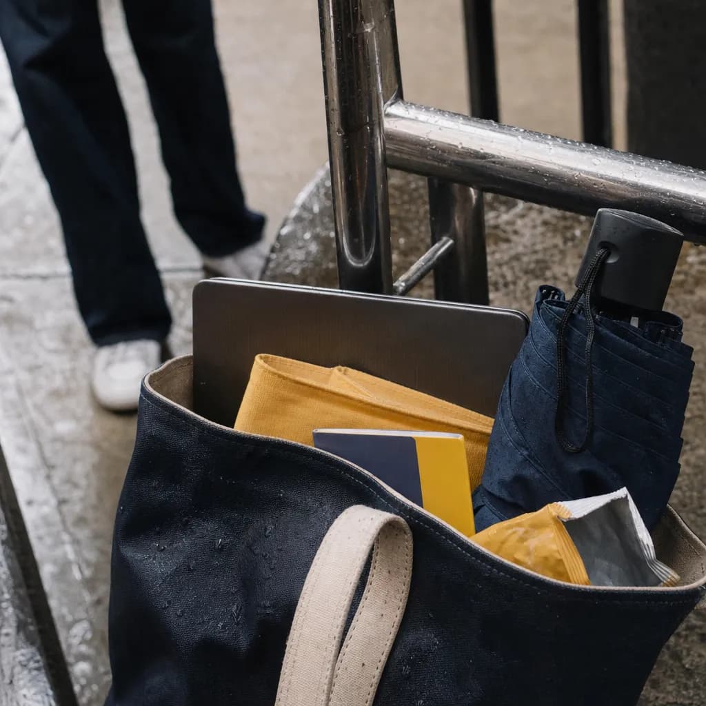 A student tote bag packed for a rainy NYC campus day