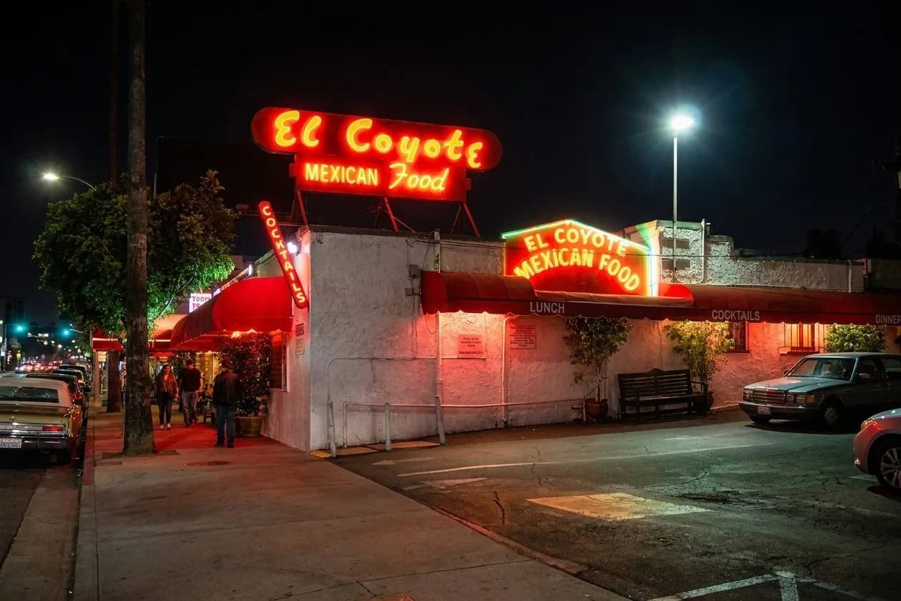 Classic restaurant exterior glowing at night on a Hollywood-adjacent street in Los Angeles