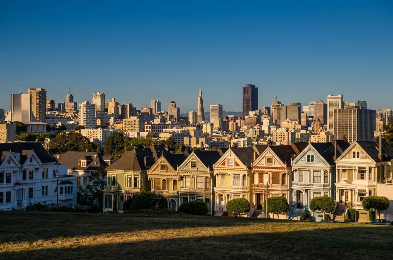 A San Francisco street of pastel Victorians in clear golden light
