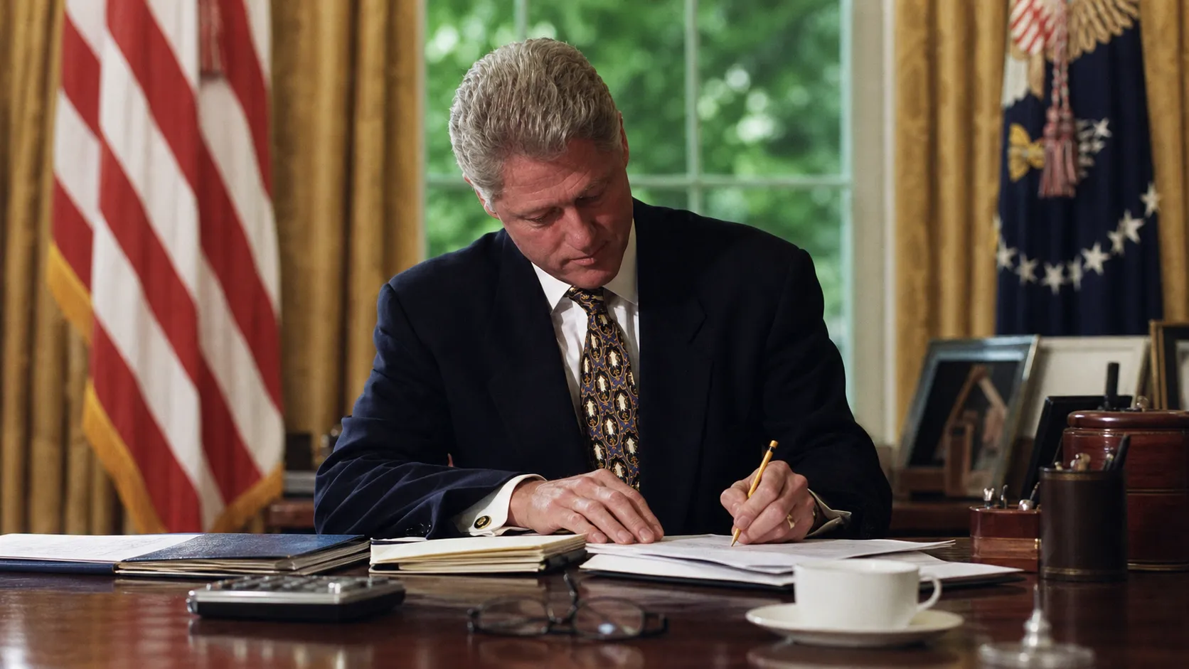 A desk with budget documents, calculator and pencil representing a taxpayer review of federal spending.