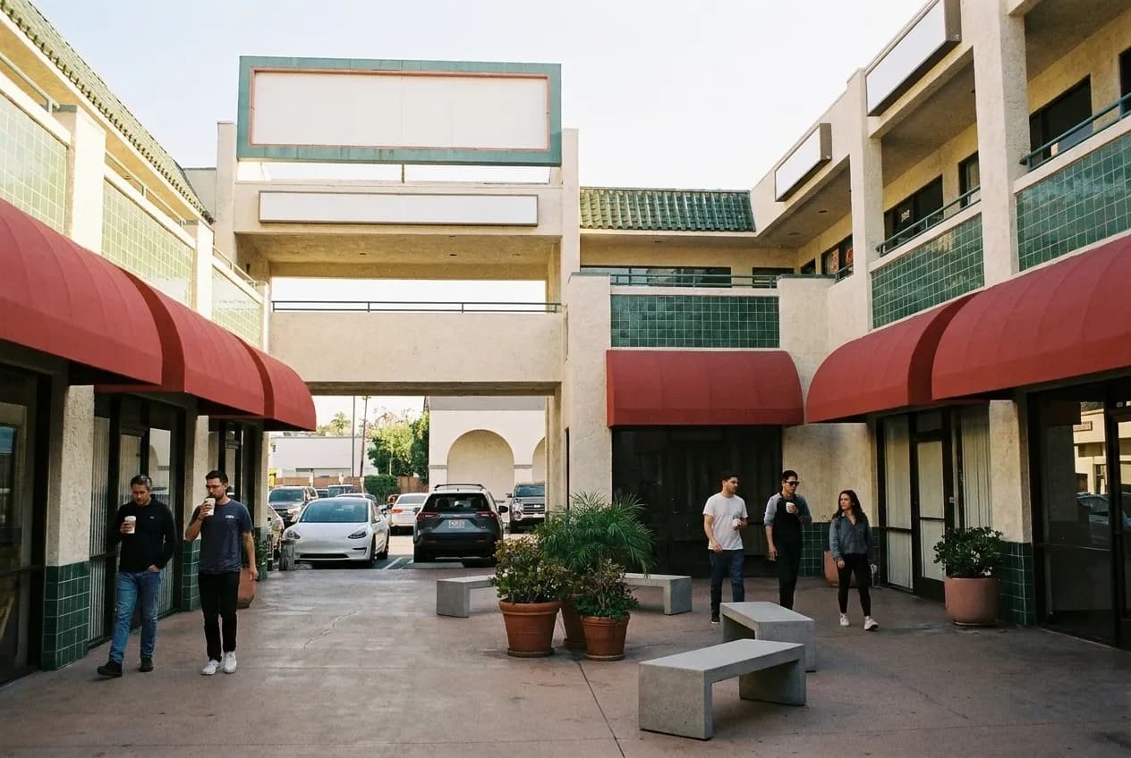 A mid-century shopping plaza courtyard in Los Angeles with two levels of small units