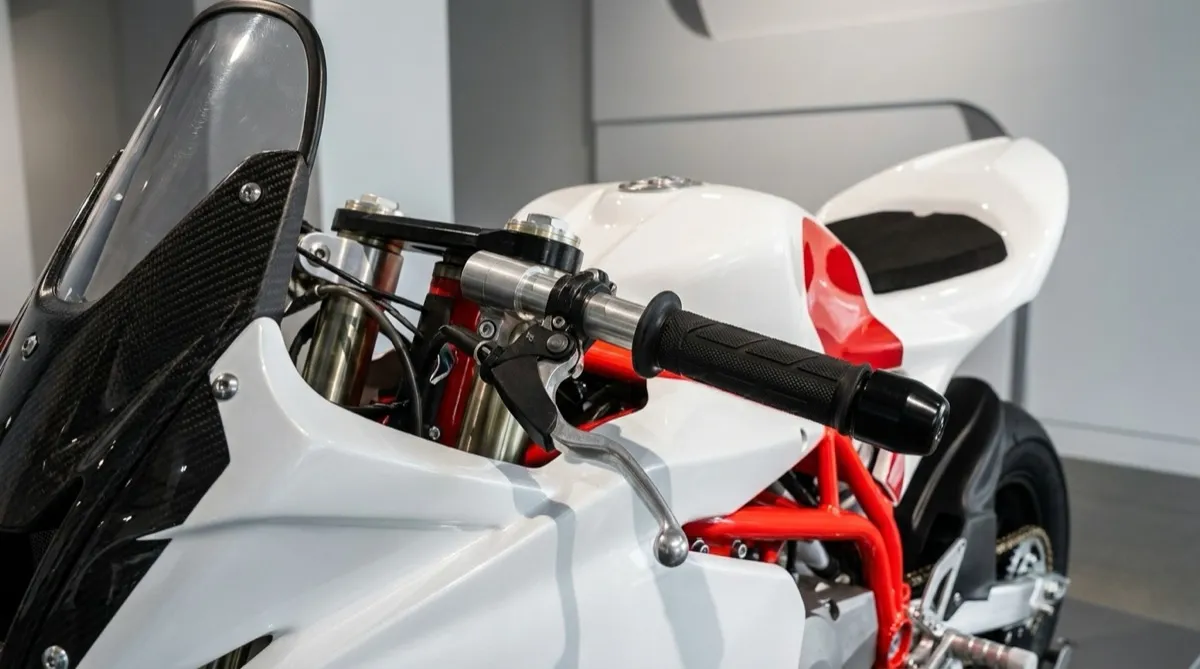 Close-up of a classic motorcycle engine and chrome details in a museum setting