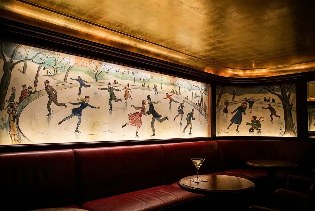The red leather booth at Bemelmans Bar beneath the hand-painted Madeline murals